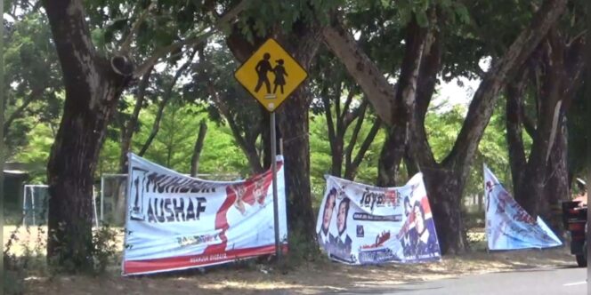 
					Banner Sosialisasi Paslon Nomor Urut Bupati dan Wakil Bupati Dipaku Dipohon, KPU Nganjuk Dikecam Warga